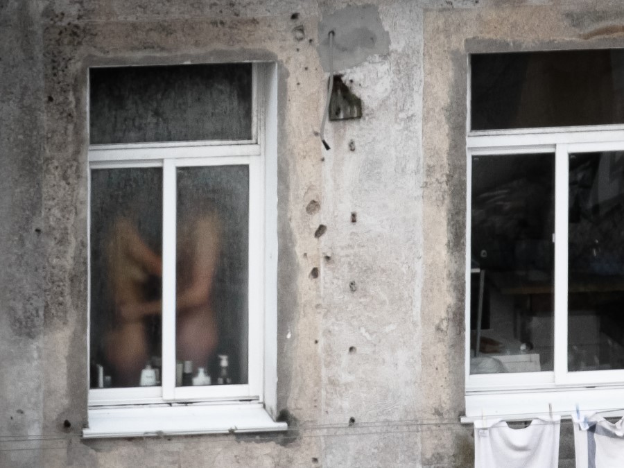 Nude women voyeured through window